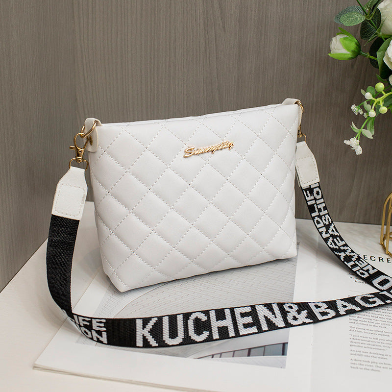 Black quilted crossbody bag with wide strap