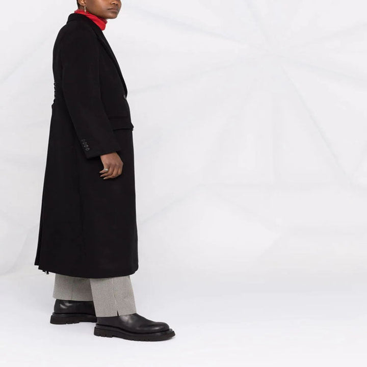 Women’s long coat in minimalist double-breasted style with tailored silhouette and flap pockets