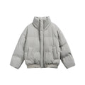 Women's short padded quilted jacket in boxy cut with high stand-up collar and ribbed hem