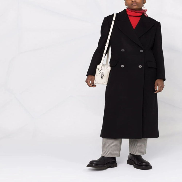 Women’s long coat in minimalist double-breasted style with tailored silhouette and flap pockets