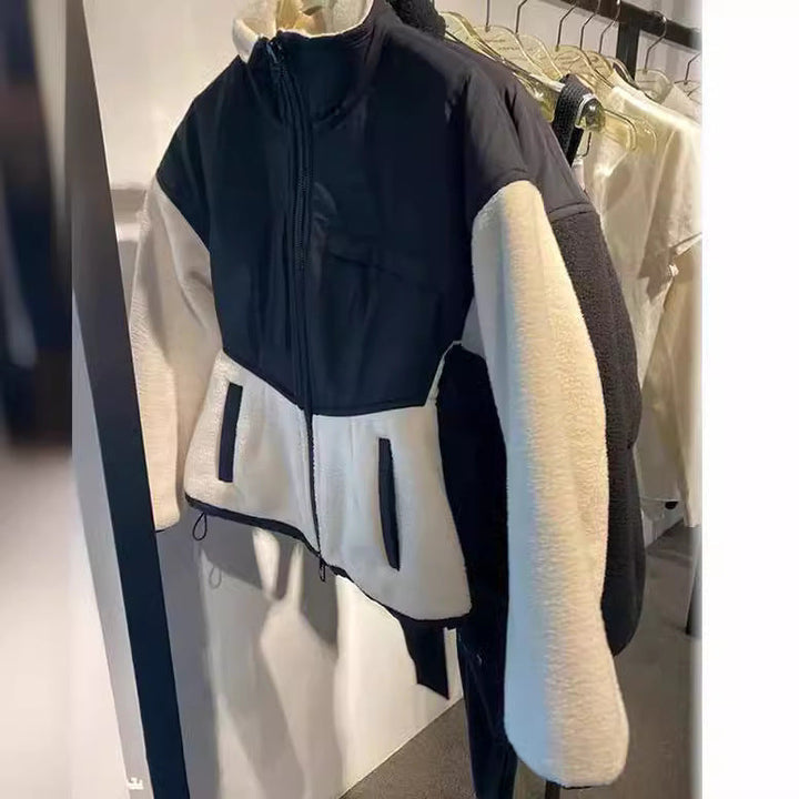 Ladies hybrid fleece jacket with padded top, stand-up collar and tailored peplum