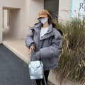 Women's slightly padded oversized quilted jacket with hood and concealed zip