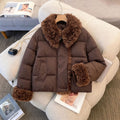 Women's short padded jacket with voluminous faux fur collar and pom pom ties
