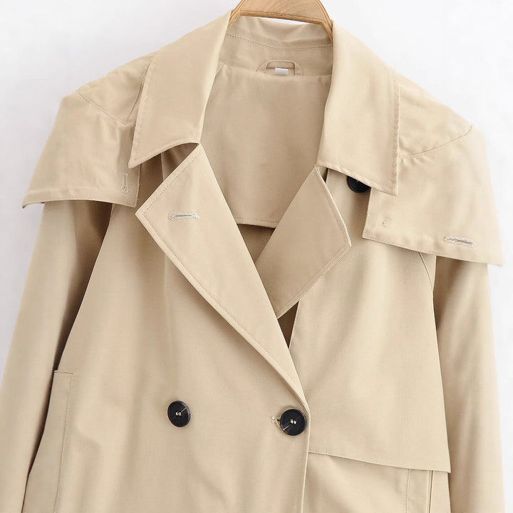 Women short jacket in trench coat style with double-breasted button placket and adjustable cuffs