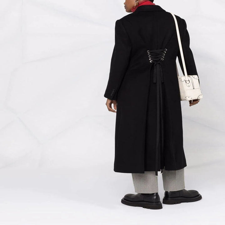 Women’s long coat in minimalist double-breasted style with tailored silhouette and flap pockets