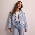 Women's quilted short jacket with V-neck, contrast piping, and floral quilted application