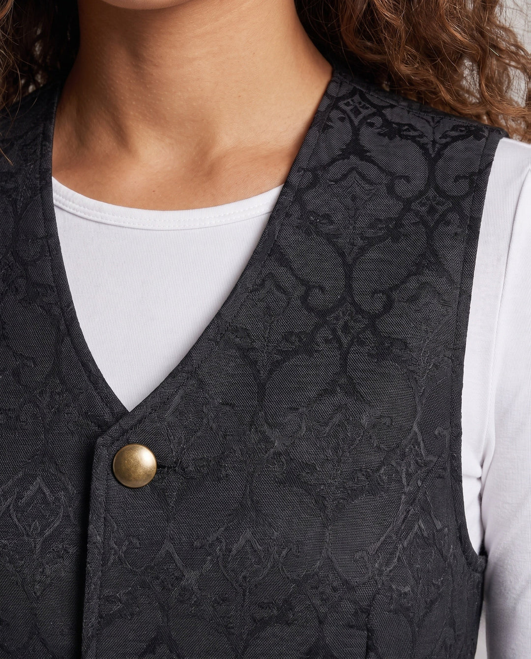 Ladies elegant vest with floral patterns and ornate buttons